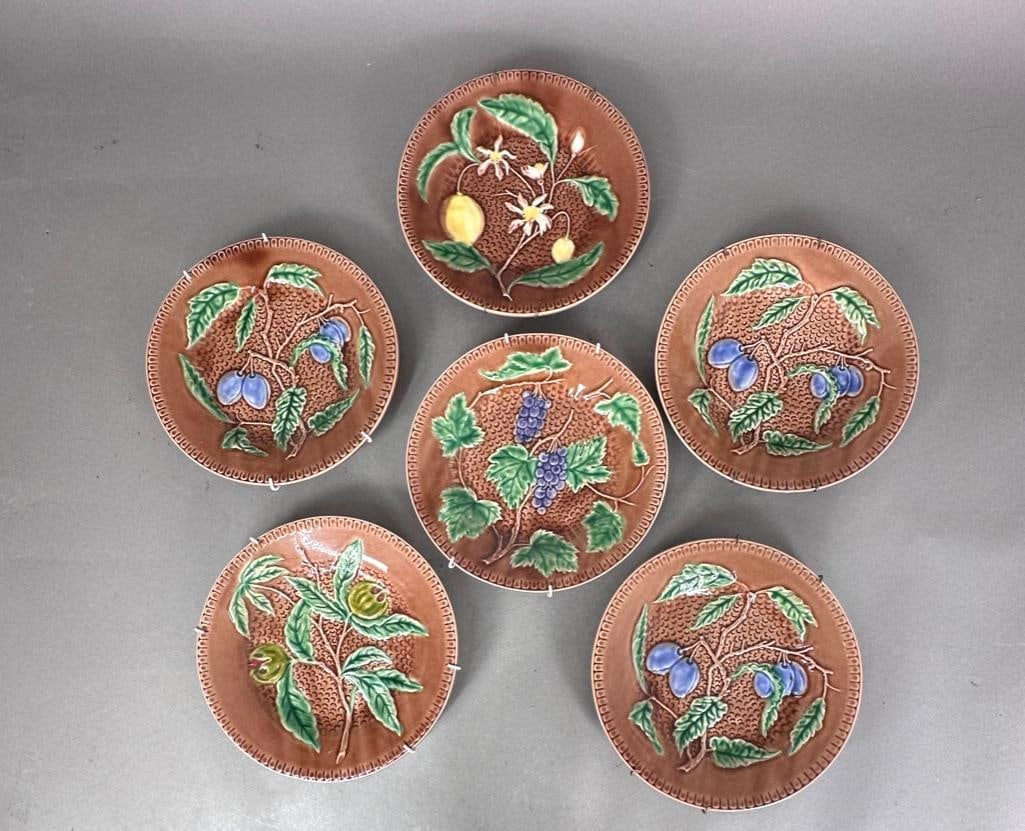 Set of Six Portuguese Majolica Plates: A set of six of majolica fruit plates by Bordallo Pinheiro, modeled with lemons and fitted into wire wall hangers. Founded in 1884, Bordallo Pinheiro is renowned for highly detailed, naturalistic majo