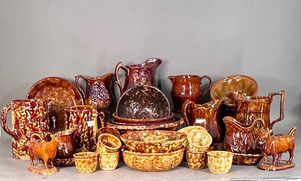 Large Collection of Bennington Style Pottery: A large offering includes bowls, plates, various pitchers in various sizes, cake molds, two cow creamers, cups and mixing bowls. Dimensions: various, bowls apprx 3"d x 3"t to 12"d x 5"