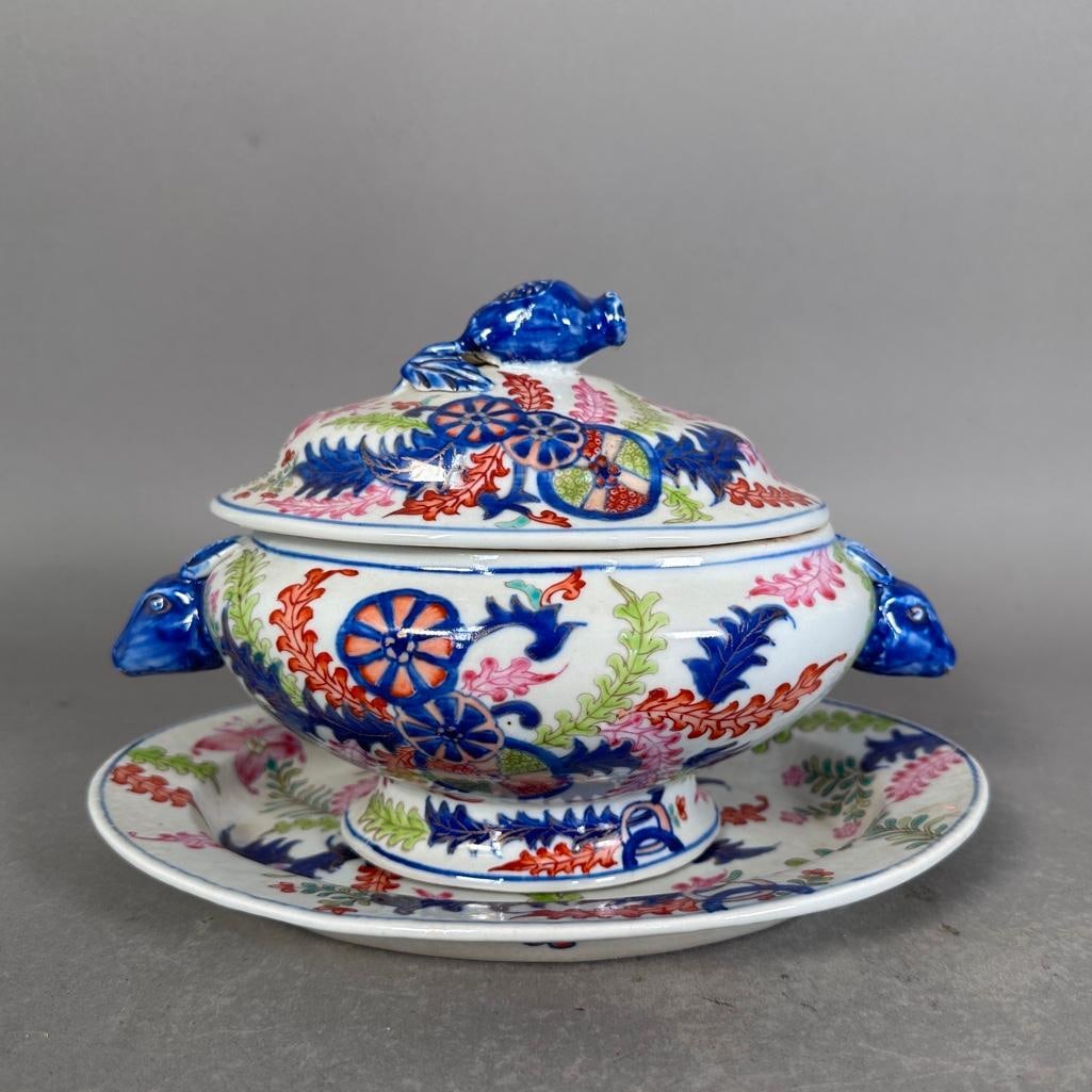 English Ironstone Tobacco Leaf Covered Tureen, ca. 1850: Richly decorated in colorful enamels and gilt details, Oval foot tureen, 6.5"H x 9"L x 5"W with animal head handles (rabbits?) with lid and lotus seed pod handle, oval liner plate10"L