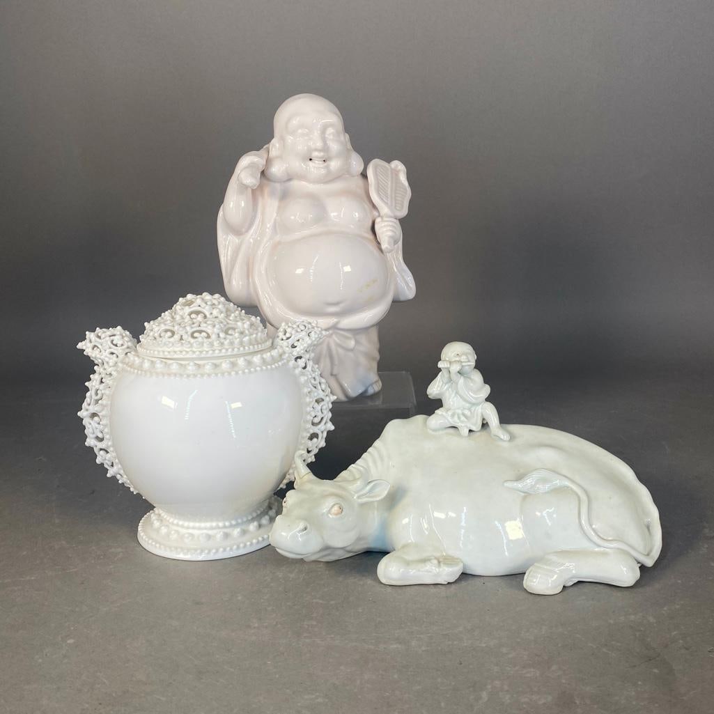Three Blanc De Chine Porcelains: Recumbent ox, with repaired horn, 4.75"T x 9"L x 5"W; Happy Buddha, 9"H; Knowles, Taylor & Knowles Lotus Ware covered vase, ca. 1895, 6.25"H, in the Persian taste, the cover
