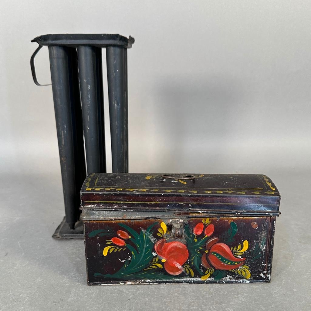 Two Antique Tins Including a Candle Mold and Tole Painted Box: Hinged lidded box with handle, hand painted with flowers, apprx 4.5"T x 8"L x 3.5"D. Candle mold apprx 10.5"T x 5" sq. Condition: surface soils, wear from age and use.