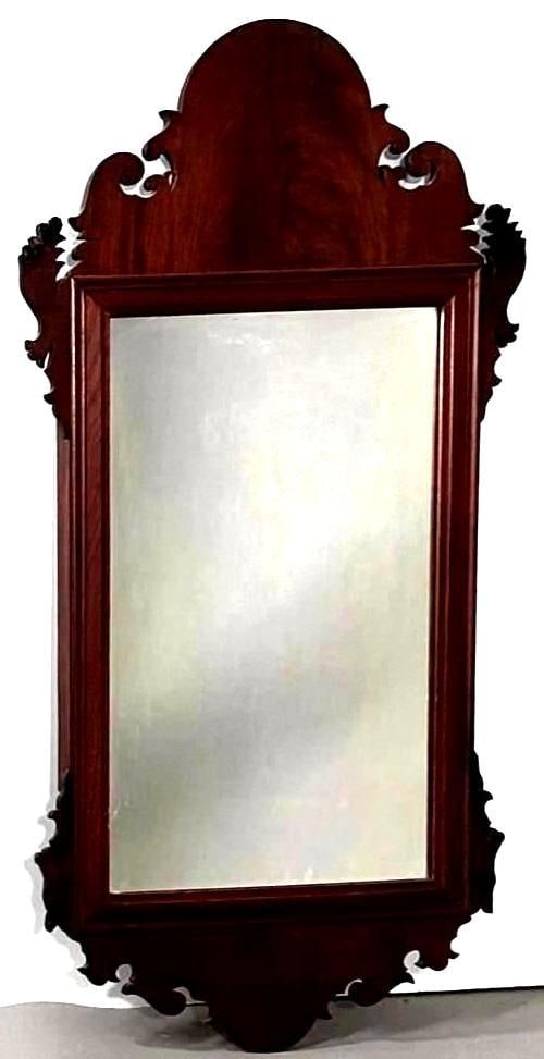Antique Chippendale Style Mahogany Wall Mirror: Warm brown mahogany wood mirror with modern glass set into frame, the panels have beautifully cut details on the ears and both upper and lower aprons, wired for hanging, apprx 38.25"H x