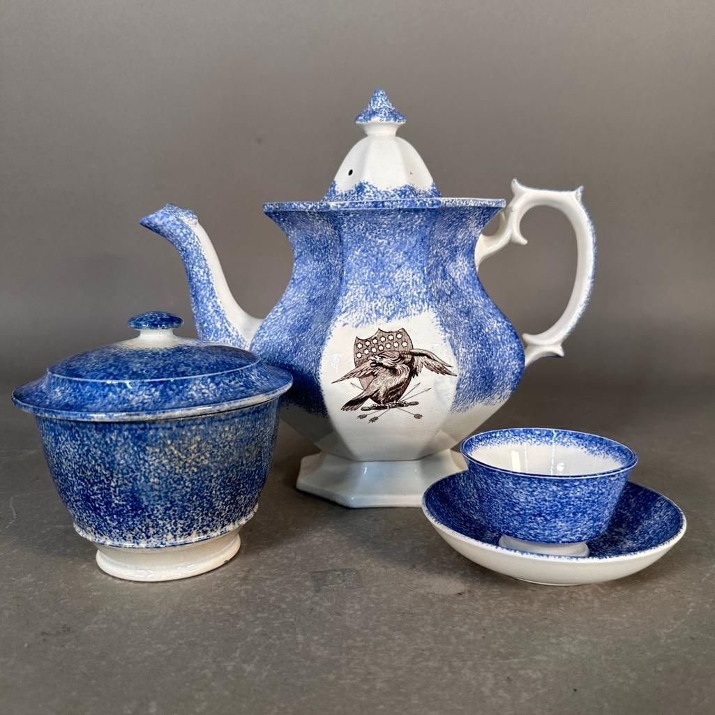Spongeware Teapot, Covered Bowl and Cup with Saucer: White ceramic with hand applied blue sponged decoration. 9"H teapot with brown transfer-ware American Eagle on US Shield with blue sponging on panels, with cover, unmarked; a footed bowl with