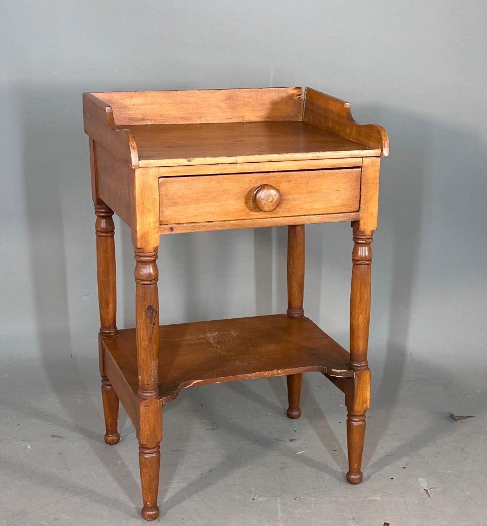 Antique Walnut Wash Stand, mid 19th century: Walnut country-style washstand featuring a single drawer, a lower storage shelf, and a three-sided backsplash on the top surface. Turned legs and warm brown finish. apprx 32"H x 20"W x