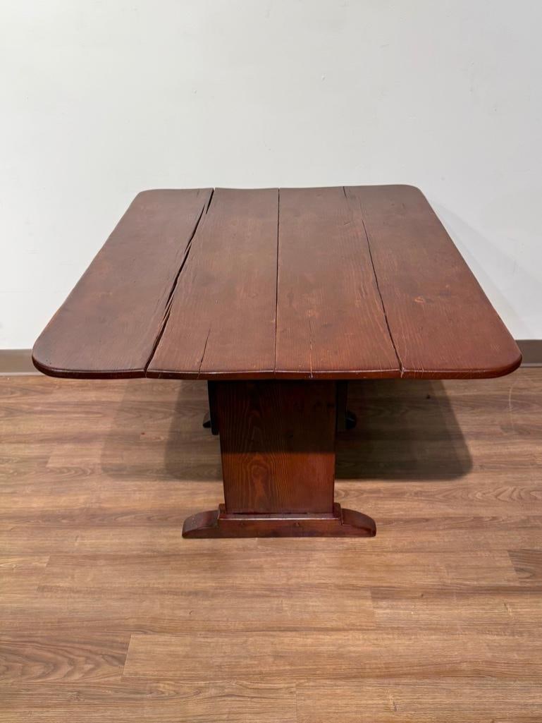 Early Pine Hutch Table: Pine table with dark stain on a shoe-foot base, having two pegs with tilt top table, revealing and interior compartment. Apprx 29H x 48 x 36 in table top. Condition: wear from use, looks to have been