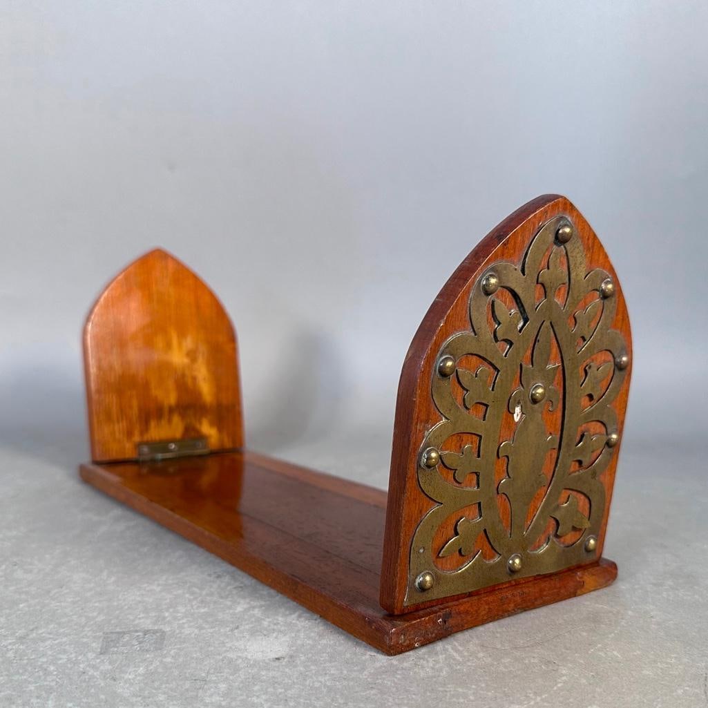 Walnut Folding Book Stand: Walnut folding book holder featuring intricate brass floral plates on hinged ends, apprx 13"L x 4.75"W x 6"T. Condition: brass lifting in small areas, good.