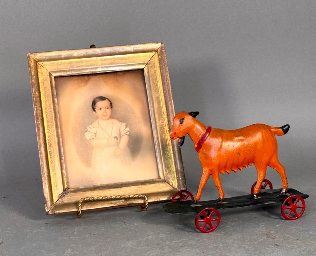 Hull & Stafford Pressed Tin Goat Pull Toy, ca. 1870-1880: Produced by Hull & Stafford of Clinton, Connecticut, pressed tin pull toy of a goalt on a platform with wheels. has been repainted, the real wheel connection detached on one side. Apprx 4.5 x 6 x