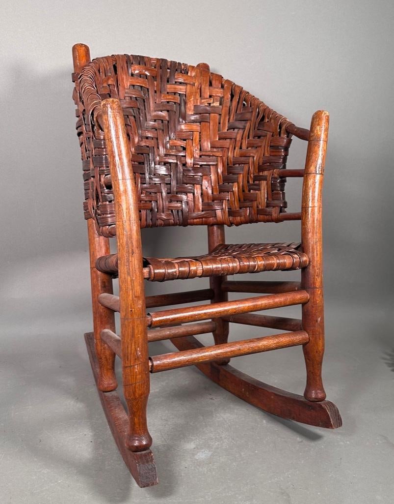 Vintage Old Hickory Child's Rocking Chair: Bentwood rocking chair, rustic styling of bent hickory wood with woven ash splints, old varnish overall, unsigned or marked, apprx 25.5"T x 15"W x 22"D measured at rocker feet. Condition: 