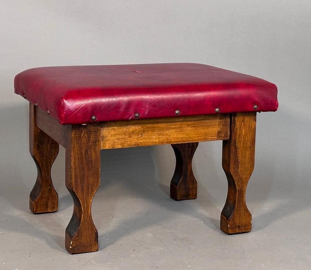 Arts & Crafts Foot Stool: Carved oak base, rustic and chunky, upholstered in red vinyl. Apprx 14.5"T x 16"D x 20"L. Condition: newer vinyl, with small teas in center top, apprx 2".