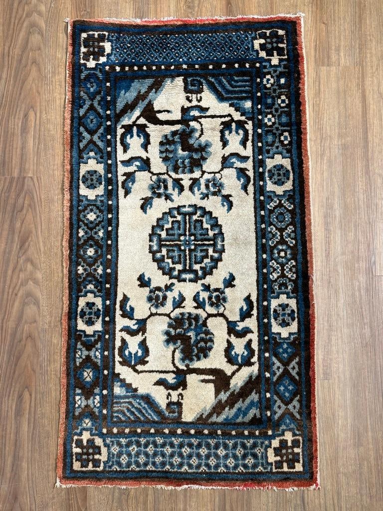 Antique Chinese Baotou Carpet 4'1" x 2'6": Ca. 1910-20, from the Mongolia region, decorated with Taoist and Buddhist symbolism. Triple blue and white hand dyed wool on cotton weft. Decorated with a Shou character medallion, vases with flowers,