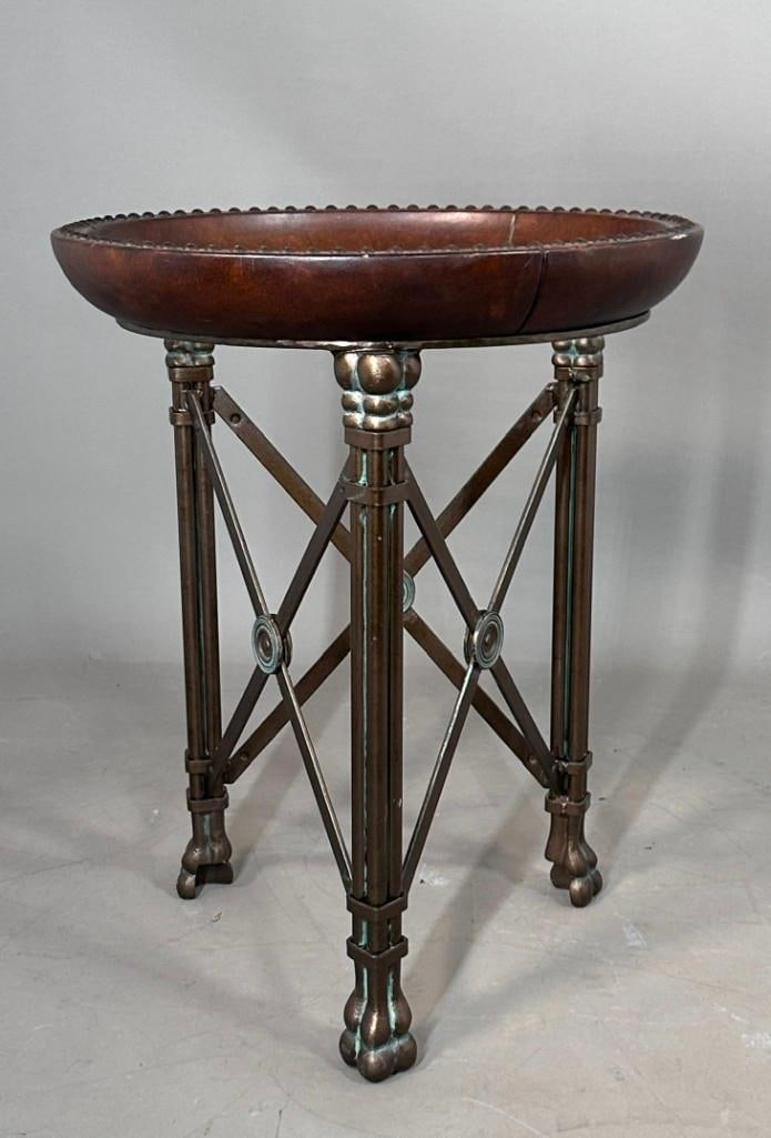 Maitland-Smith regency Style Side Table: Regency-style iron and leather side table. The base consists of a three-legged, tripod wrought-iron structure finished in a patinated dark bronze with verdigris highlights. The tray-style upper basin 