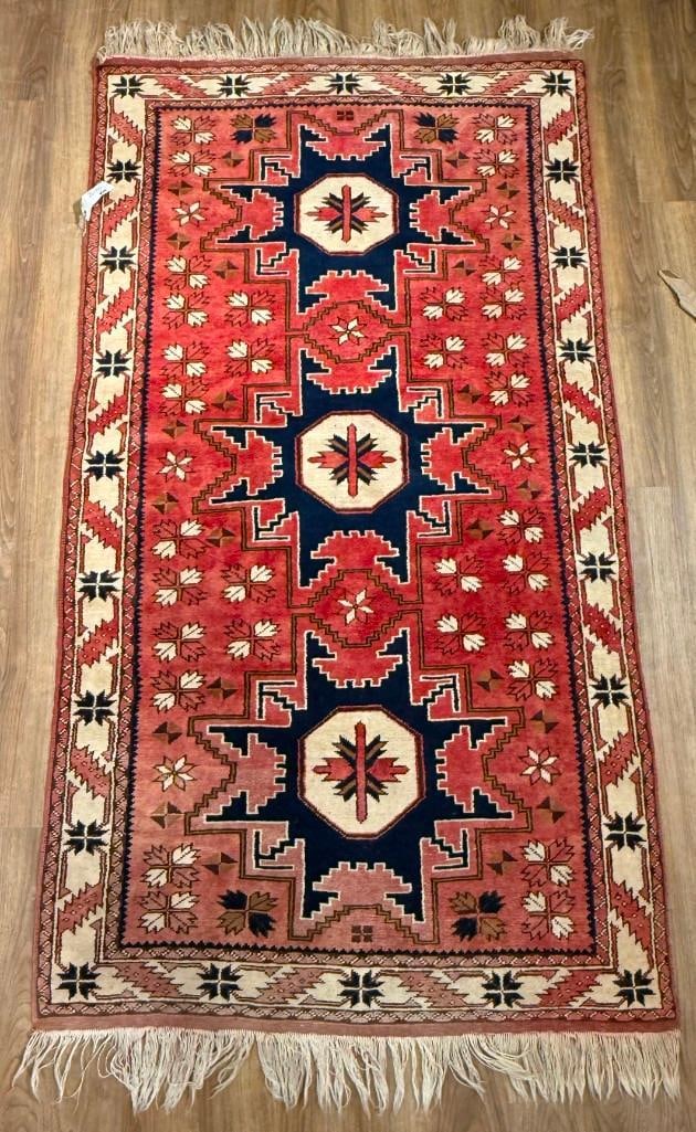 Persian Karaja Carpet 6'4" x 3'6": Hand-knotted antique Persian Karaja carpet, or runner.Central axis with three repeating medallions.Classic northwestern Persian color scheme, dominated by a vibrant coral/madder red field. This field 