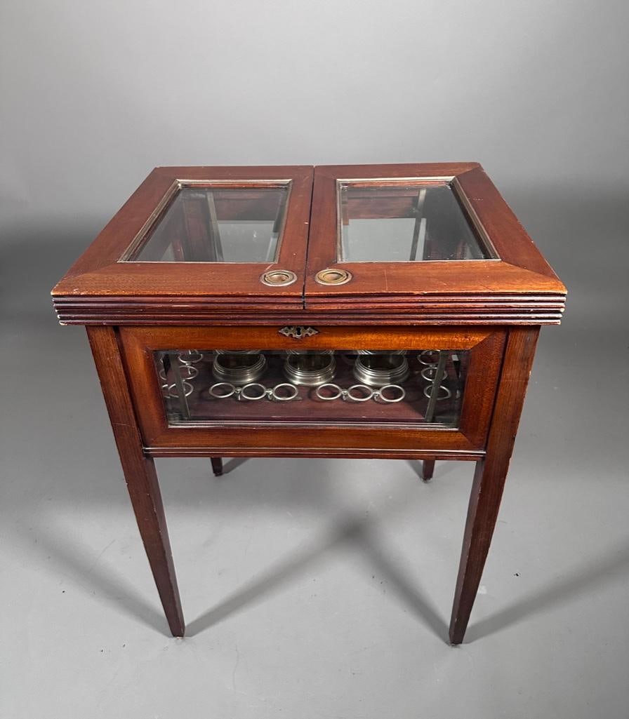 Mahogany Lift-Top Demilune Bar: Mahogany lift-top mechanical decanter server. Missing bottles and glasses. Apprx 30"T x 23.25"W x 19.5"D. Condition: missing on of the castor feet, but three are present but removed for stability.