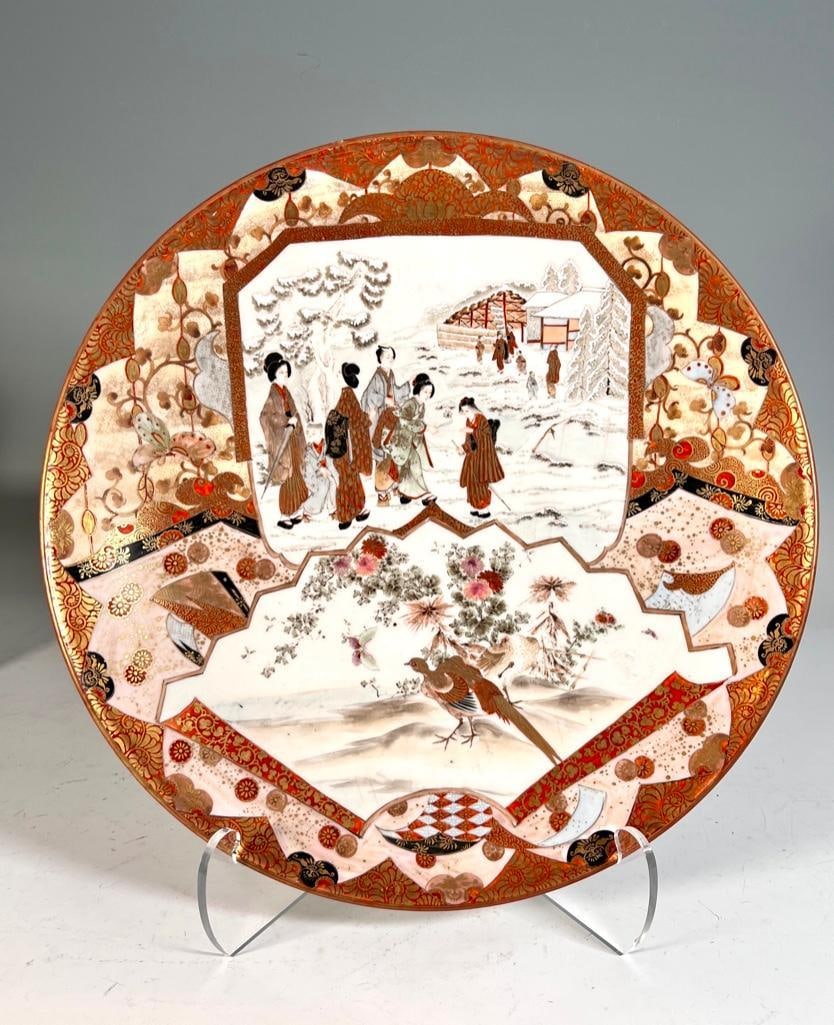 Large Japanese Kutani Charger: Large Japanese Kutani Charger, late 19th-early 20thc. Decorated with beauties and attendants traversing though the snow and a pheasant in a garden with a moth, each scene reserved on a highly decorate