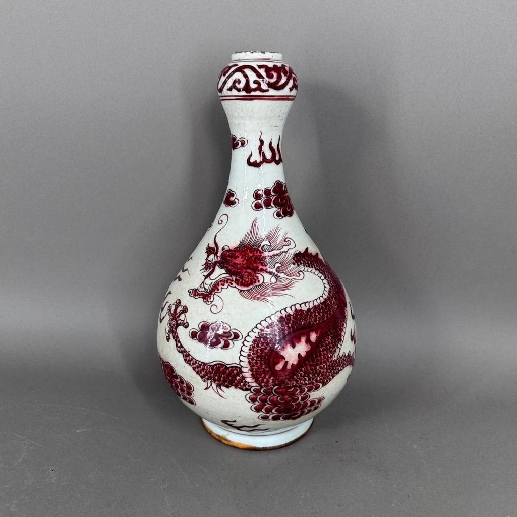 Chinese Red Iron Glaze Porcelain Vase: Chinese Red Iron Glaze Porcelain Vase, apprx 14''H x 8.5''D. Painting of a dragon chasing the Flaming Pearl amidst clouds and fire. Small round foot and bulbous neck, no marks.