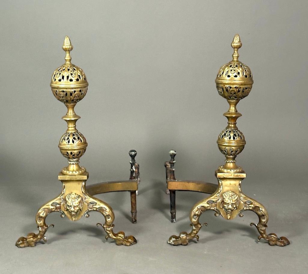 Pair of Antique Brass English Style Andirons: Reticulated ball over knopped stem, topped with an acorn finial. Raised over cat-like grotesque mask and hairy legs with paw feet. Unmarked or signed. Apprx 22.5"T x 13" x 22". Condition: antique, pre