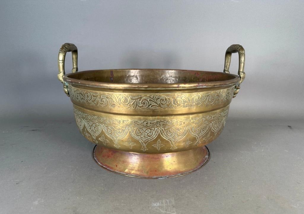 A Large Indian Brass Food Warmer: With a molded circular foot, engraved decoration, open handles. Bowl only, does not have the inner container or lid. Apprx 10-1/2"T to top of handles x 16"D. No marks. Condition: wear and losses to br