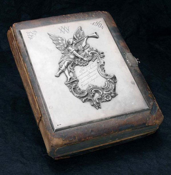Russian Antique Photograph Album with Silver Plaqu: Russian Antique Photograph Album with Silver Plaque. Well done solid silver Plaque decorated with an angel playing a horn. Marked 84 standard and “AP”. A Presentation inscription by Cyrillic “Fo