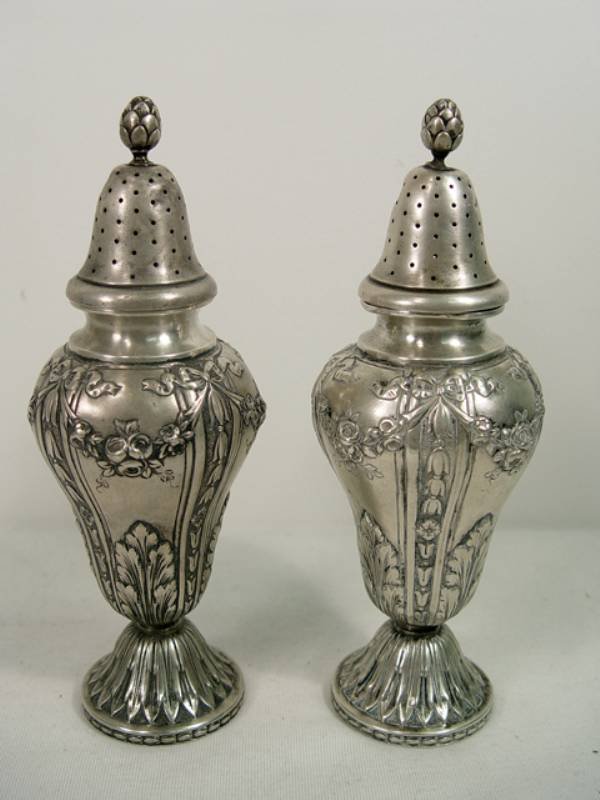 Pair of Antique French Silver Shakers. Early 1800s: Pair of Ornate Antique Silver Shakers.Possibly French Colonial. Early 1800s. Hallmarked by Maker. Each is approx.7-1/2" high x 2-3/4" wide.