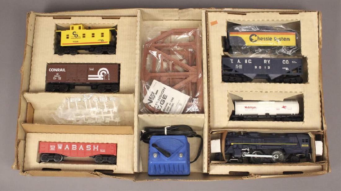 Lionel 6-1052 Chesapeake Flyer Train Set: This set includes a powered steam locomotive with headlights and puffing smoke, tender, boxcar, hopper, tank car, gondola with canister load, caboose, set of 14 road signs, eight curved track sections