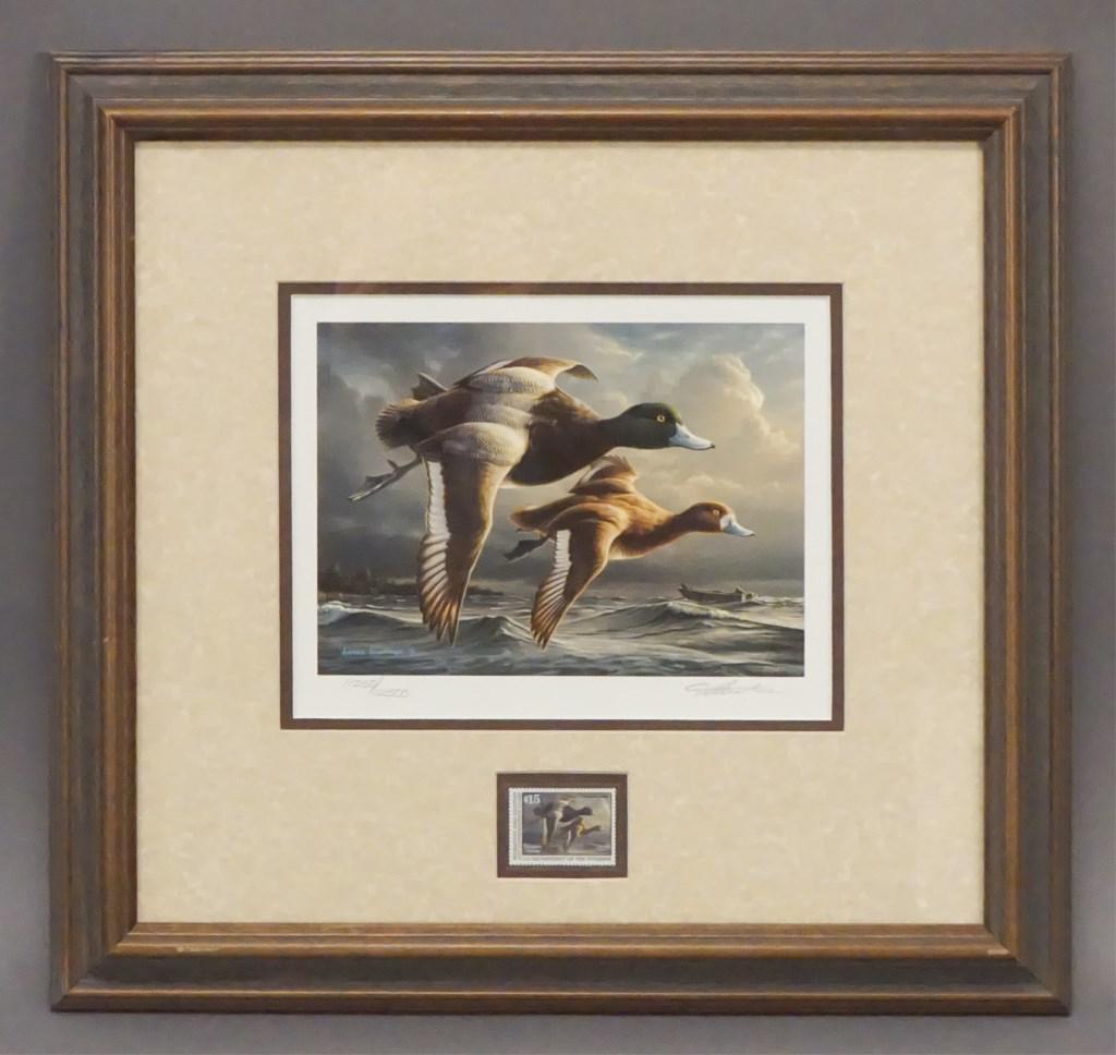 James Hautmann "Greater Scaup" Print with Stamp: 1999 - 2000 Federal Duck Stamp by James Hautman Two blue bill ducks flying in the foreground with a Duck boat and black lab in the back ground. Signed & Numbered 11250 / 12500. Migratory Bird Hunting