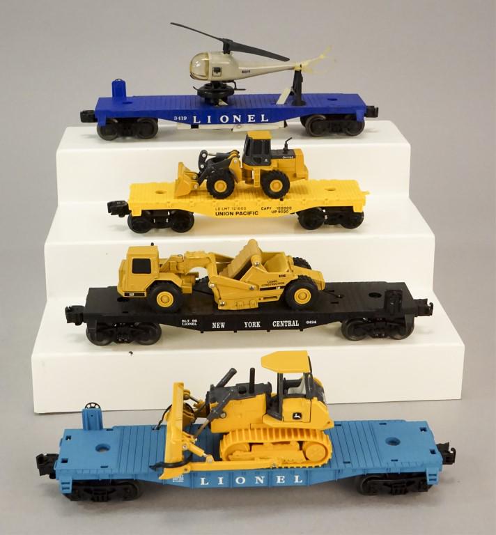 4 Lionel Flatcars with Helicopter - Bulldozer: Flatcar Navy helicopter -3419, 613 Lionel Cat Dozer, Union Pacific flatcar with John Deere dozer, Lionel flatcar with John Deere Dozer. [ARN 120]