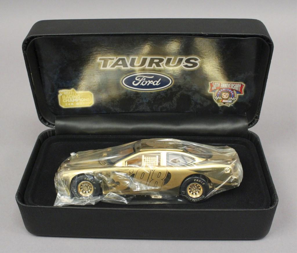 1998 Racing Champions 1:24 Gold NASCAR 24K #98: Ford Taurus NASCAR 50th Anniversary 24K Gold #98 with certificate of authenticity. [JLD 125]