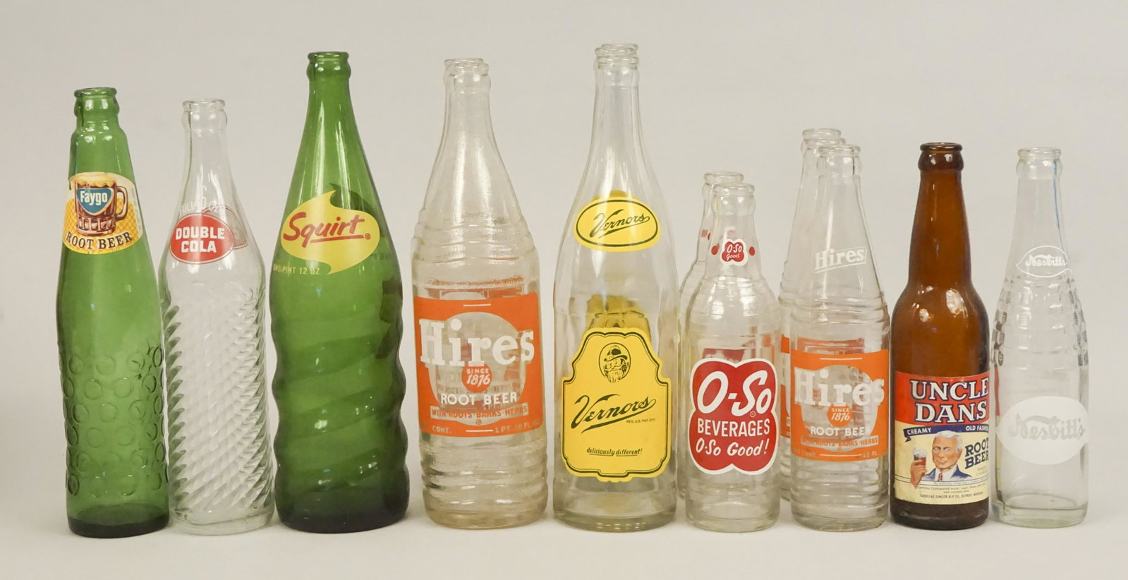 Vintage Soda Bottles - Faygo - Vernors - Hires: Bottles include Faygo Root Beer, Double Cola, Squirt, 2 - 26 Oz. Hires Root Beer, 3 Vernors, O-So Beverages, Uncle Dans, 3 - 12Oz. Hires Root Beer & 1 Nesbitt's. [DBA 170]