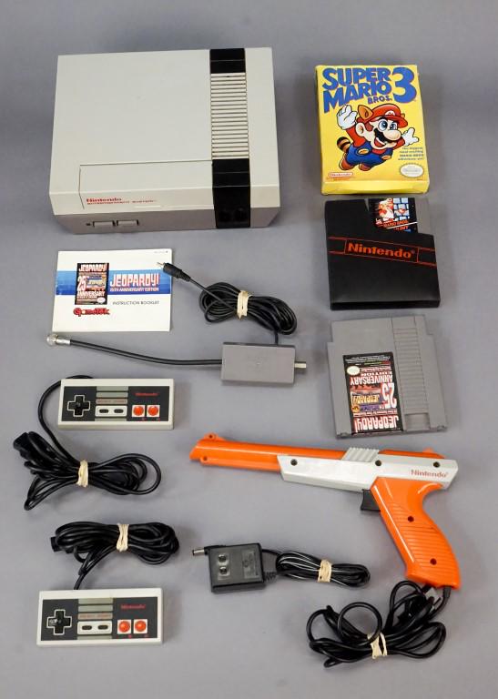 Original Nintendo NES with Games & Controllers: Working Original Nintendo NES Gaming console, including 2 original controllers and duck hunt "gun" controller. Included games: Super Mario 3, Duck Hunt (with protective sleeve), and Jeporady! 25th Ann