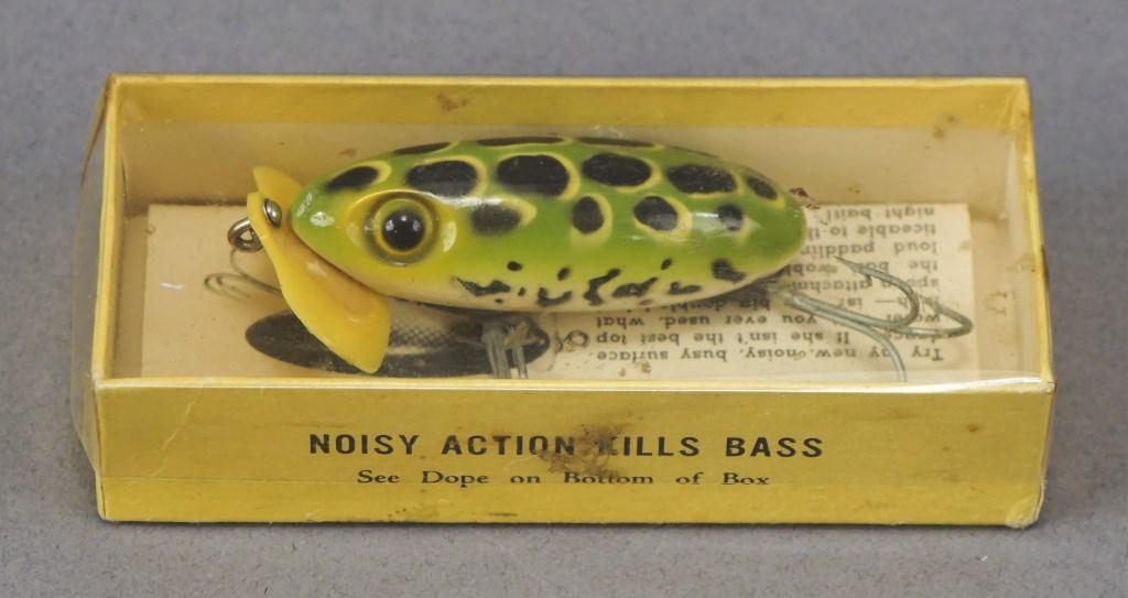 Fred Arbogast Jitterbug Plastic Lip Lure w/ Box: Also has paper. 1940's war years when metal was allocated for WWII efforts. Lip was re-designed with plastic. Watch for hundreds of fishing lures, many in boxes, later in the auction. Good luck! [MAB 