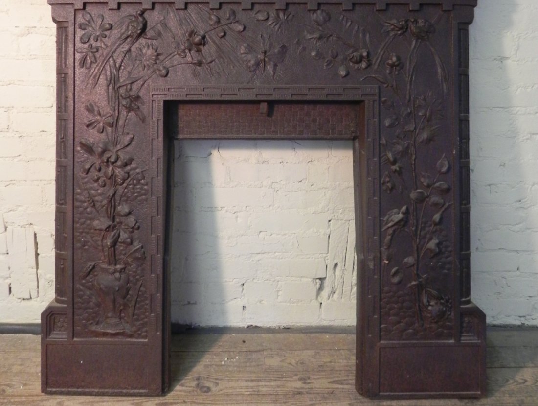 Aesthetic Movement Cast Iron Fireplace Surround: Beautifully decorated with birds, flowers, butterflies, and different patterns. No foundry marks or other marks that we can find. Measures 45" high by 45 1/4" wide by 5 7/8" deep. Comes with marble to
