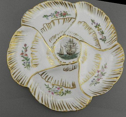Haviland Limoges Oyster Plate w/Ship: Unusual imagery inside the center well. Plate measures just under 9" across and is nearly perfect. There is a small flake inside the foot ring.