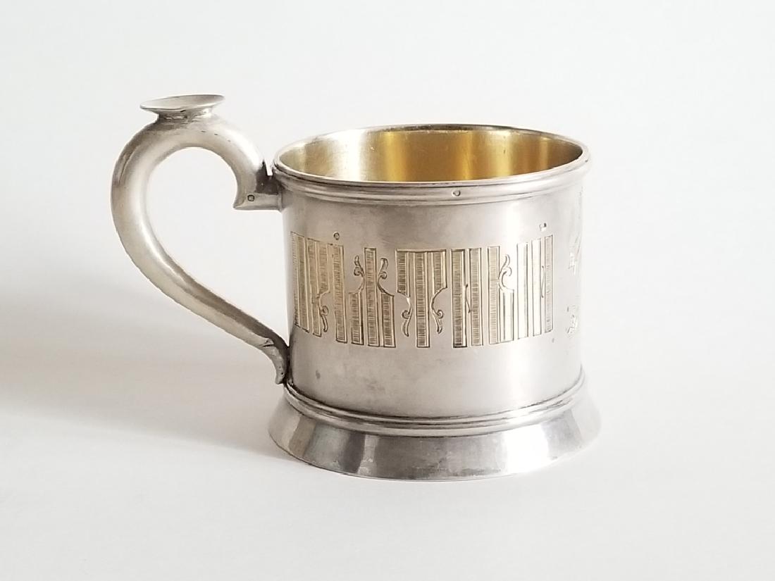 19C Russian Gilt Silver Tea Glass Holder: ANTIQUE RUSSIAN SILVER TEA CUP HOLDER by Grachev Brothers . THE TEA CUP HOLDER IN PAN SLAVIC STYLE WITH CYRILLIC LETTERS ON BOTH SIDES and RUSSIAN HUT ENGRAVING ON THE MIDDLE . GOLD WASHED INTERIOR .