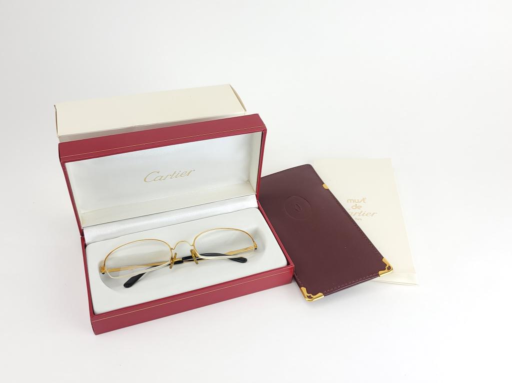 Original Cartier Eye Glasses Box Papers: Original Cartier gilded eye glasses with box, papers and leather case. Set with cabochon supphire stones on temples. Condition: very good,, few times used.