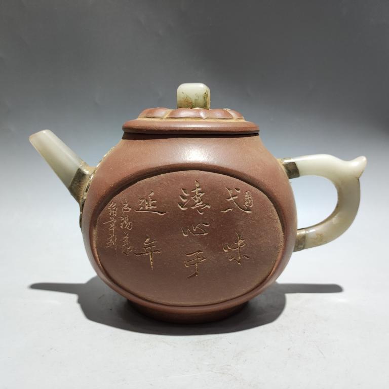 Chinese Zisha Teapot w Calligraphy,Mark: 3.3cm L 1.9cm W 7.9cm H Please note the absence of a condition report does not imply that there are no condition issues with this lot. Please contact us for a detailed condition report.