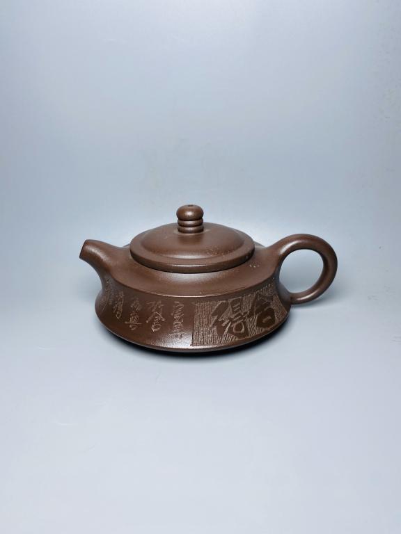 Chinese Zisha Teapot: 7.5cm H 15cm W Please note the absence of a condition report does not imply that there are no condition issues with this lot. Please contact us for a detailed condition report.