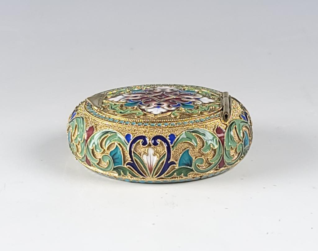 Russian Silver Enamel Pill Box: Russian gilt silver and Cloisonne Enamel Pill or snuff box. Weight 76 gm. Size: 2 1/4" ( 5,5 cm ) diameter. 0.75" ( 2 cm ). Hallmarked inside for Grachev Brothers, 84, Imperial Warrant and on the rim.