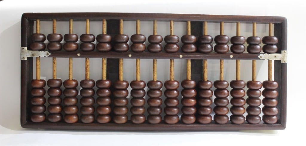 A Hongmu Wood Abacus: A Hongmu Wood Abacus. 7" by 16 1/4" Please note the absence of a condition report does not imply that there are no condition issues with this lot. Please contact us for a detailed condition report.