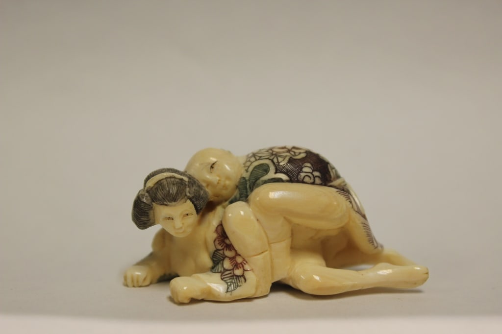 Japanese Hand Carved and Painted Figurine Netsuke: Japanese Hand Carved and Painted Figurine Netsuke. Dimension:2"Long.The figurine depicts two human figures in an erotic embrace, which connects it to the Japanese tradition of shunga netsuke. The garm