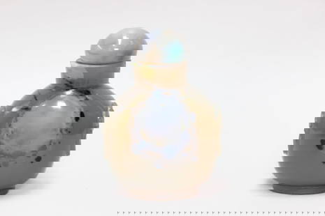 Chinese Agate Snuff Bottle: Dimension:2 1/4"HThe bottle is carved from a single piece of agate, a type of chalcedony. The stone has a translucent, brownish-gray base color with darker markings, as well as a prominent, lighter-co