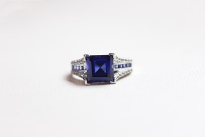 An emerald-cut Blue Crystal Ring