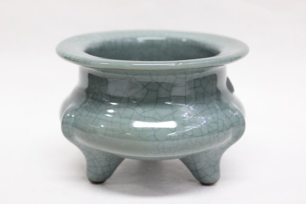 Chinese "Guan-type" Ceramic Tripod Censer: Chinese "Guan-type" ceramic tripod censer (incense burner) with a characteristic crackle glaze. Dimension: 4 1/2"W It features a thick, unctuous celadon (pale greenish-gray-blue) glaze with a distinct