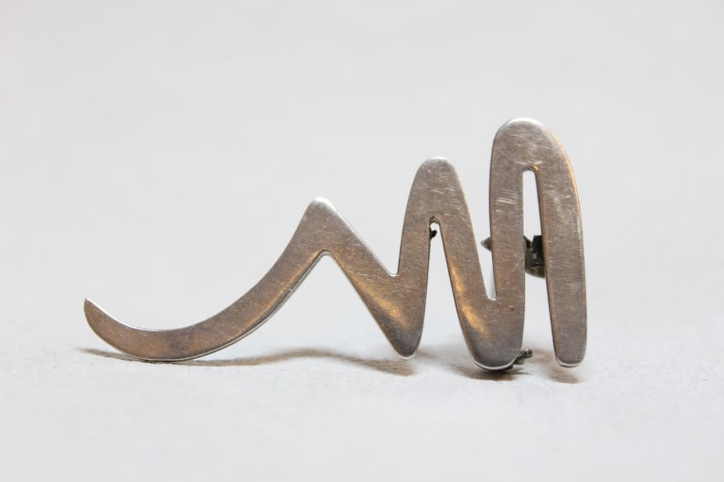 Sterling silver "Scribble" Brooch: Dimension:2" is a sterling silver "Scribble" brooch, a classic piece designed by Paloma Picasso for Tiffany & Co.. It is part of her iconic "Graffiti" collection, first released around 1983 or 1985.