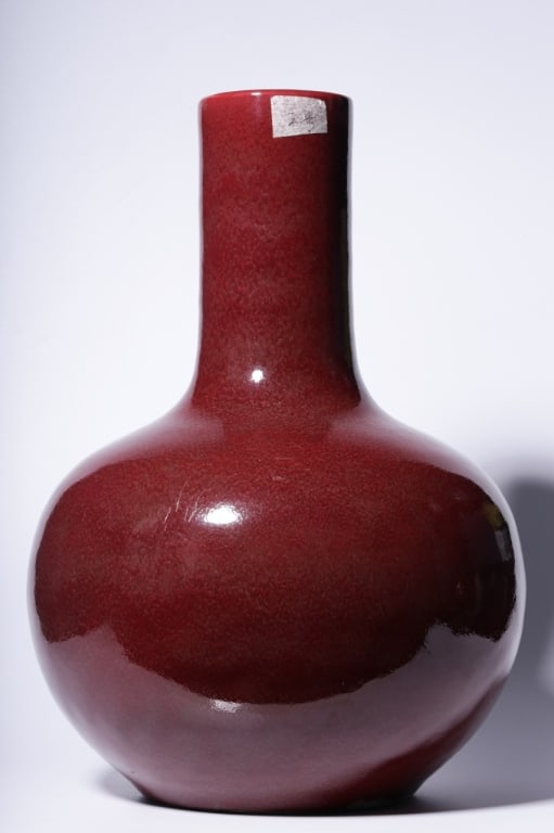 Chinese Sang De Boeuf Porcelain "Bottle" Vase: Dimension: 34cm H x 23.5cm W ,weight is3163gram. The glaze is a rich, deep, and glossy crimson or "crushed strawberry" red derived from copper oxide, which requires a technically challenging firing pr