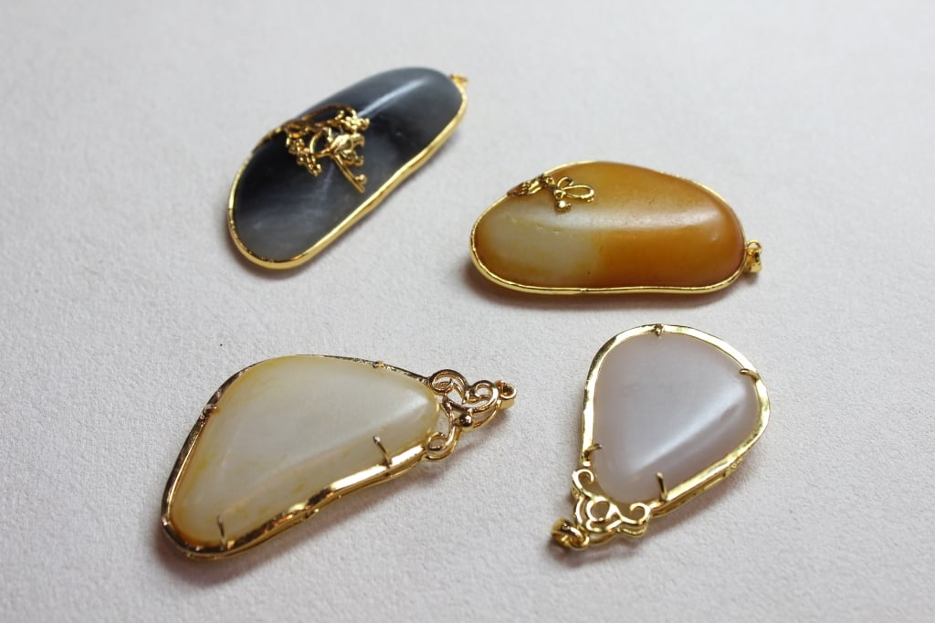 Collection of four Chinese carved Jade pendants (1 of 4)