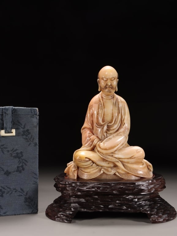 Finely Chinese Carved Statue of an Arhat: Dimension: 15.5cm H x 12cm L x 8.5cm ,weight is1018gram. The figure is a bald monk with a beard and mustache, depicted with a serene yet intense expression. He is wearing monastic robes with delicatel