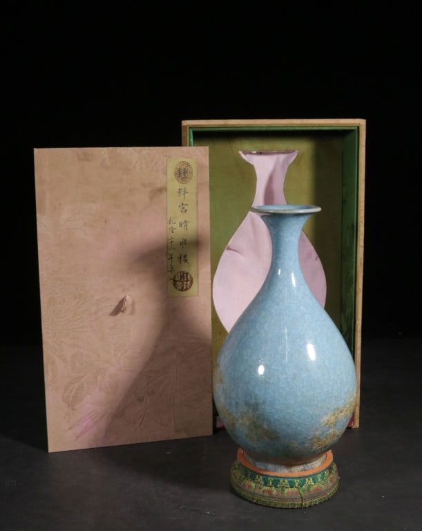 Chinese Celadon-glazed Porcelain "pear-shaped"Vase: Dimension: 27cm H x 15.5cm. It has the elegant yuhuchunping form, which includes a bulbous body that gracefully tapers to a tall, slender neck and a slightly flared mouth. A key feature is the