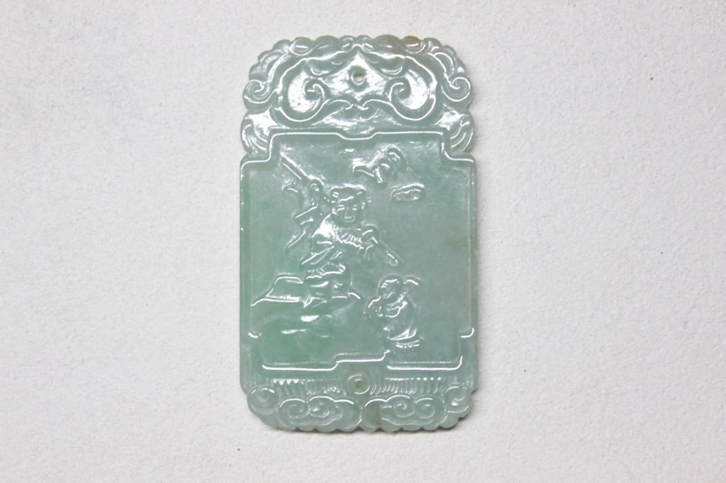 Chinese Carved jadeite Plaque Pendant: Chinese Carved jadeite Plaque Pendant Dimension: 4cm x 6.5cm. The top and bottom of the plaque are framed with Ruyi-head clouds. "Ruyi" (??) literally means "as you wish," symbolizing good fortune and