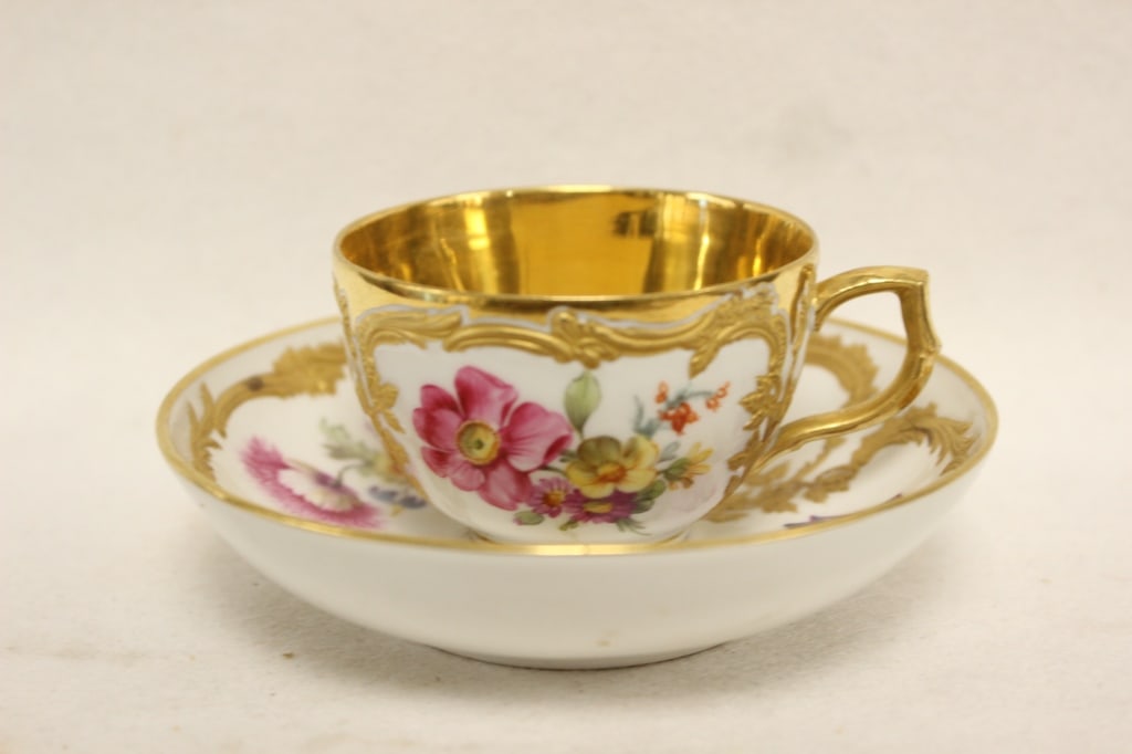 Antique KPM Porcelain Teacup and Saucer Set: Dimension: plate is 11cm W This set features the Neuzierat (New Ornament) pattern. First designed in 1764 by Friedrich Elias Meyer, it is characterized by its elegant, curved shape and rocaille