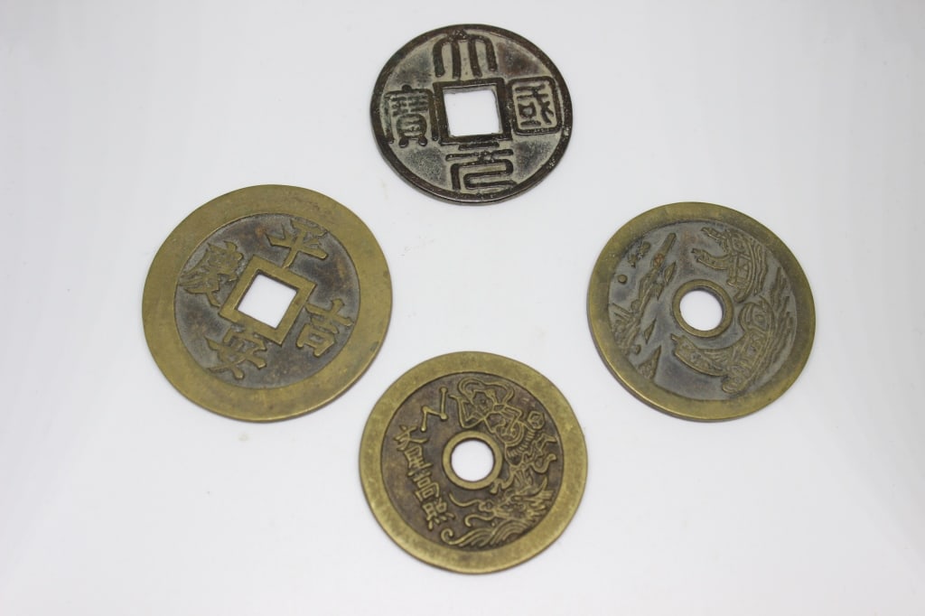 Four Chinese Copper Coins: Dimension: 8"H. The clear glass body features a distinctive spiral-moulded or "thread glass" pattern that tapers into a pedestal foot. The neck, spout, and ornate handle are made of